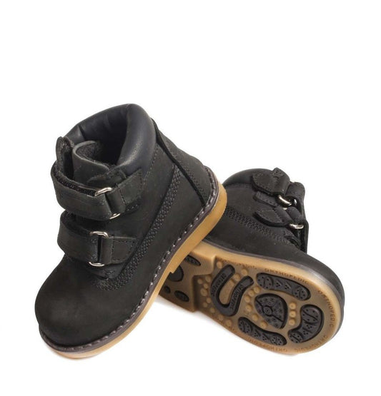 Pair of black children's boots with brown soles on a white background