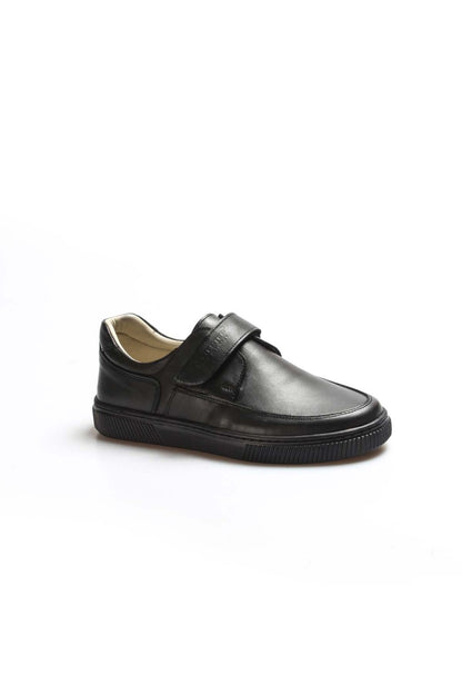 Black leather shoe with a strap on a white background