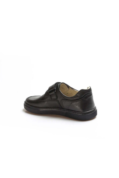 Black school shoe on a white background