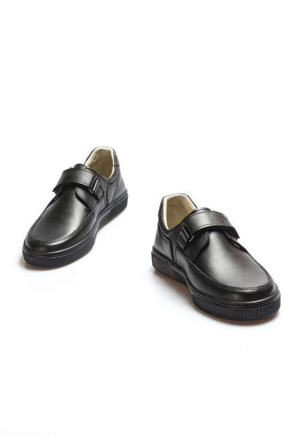 Pair of black shoes with velcro straps on a white background