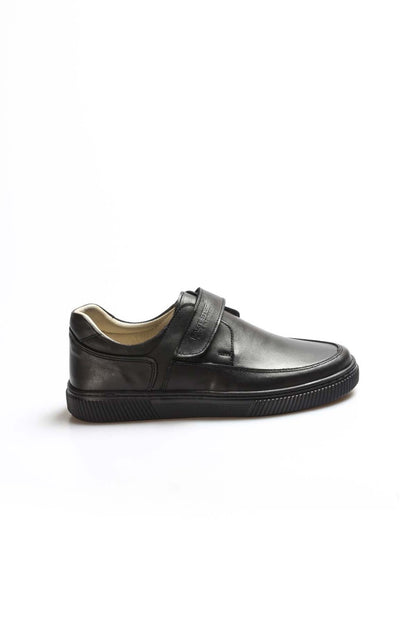 Black leather shoe with a strap on a white background