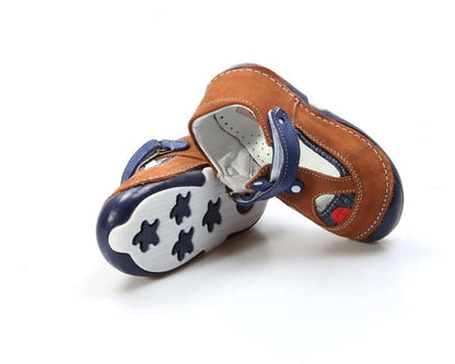 Pair of children's sandals with brown, blue, and white design on a white background